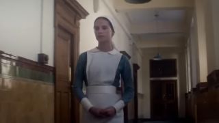 Alicia Vikander as a nurse, walking down a hall in Testament of Youth