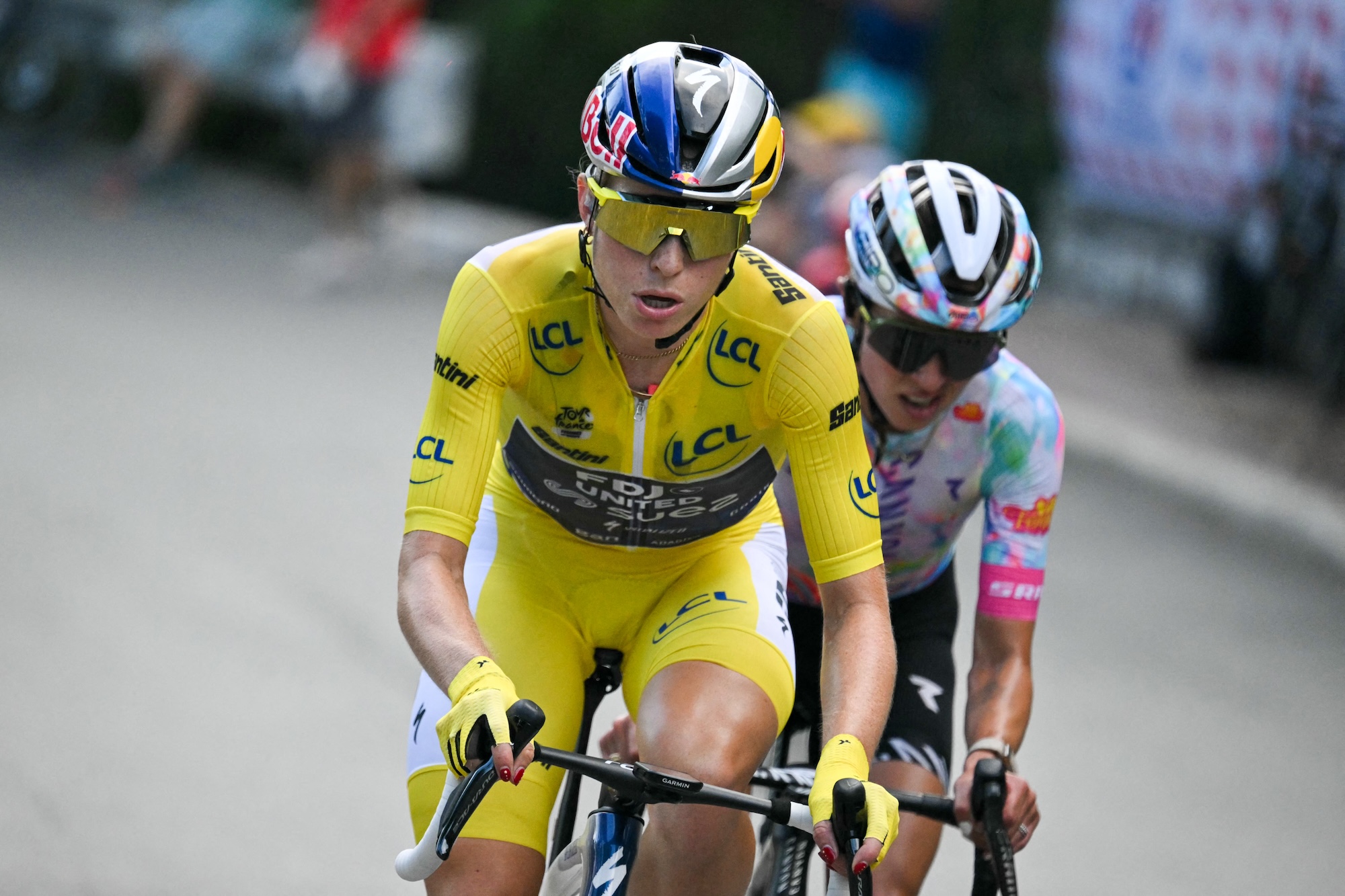 FDJ-SUEZ's rider Demi Vollering wearing the overall leader's yellow jersey (L) and Canyon//SRAM's Katarzyna Niewiadoma ride in a breakaway during the 9th and final stage of the fifth edition of the Women's Tour de France