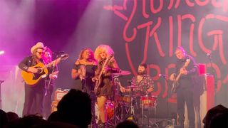 Marcus King and Grace Bowers playing guitar on stage