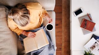 A woman reading with a coffee cup