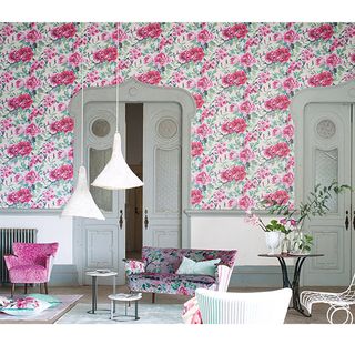 living room with pink floral printed wallpaper on wall