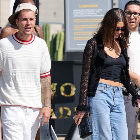 Justin bieber and hailey bieber walking in L.A. Hailey wears a black top with low-rise jeans.