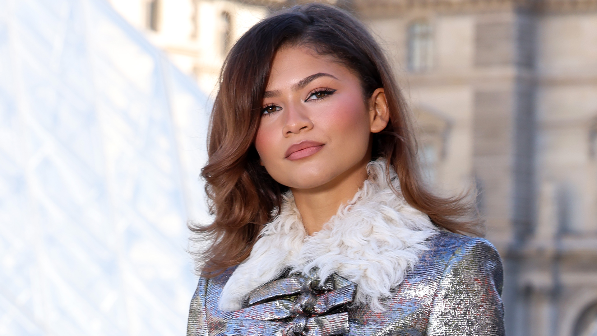 Zendaya posed with fans in Paris wearing a white tank top and sparkly micro-mini shorts