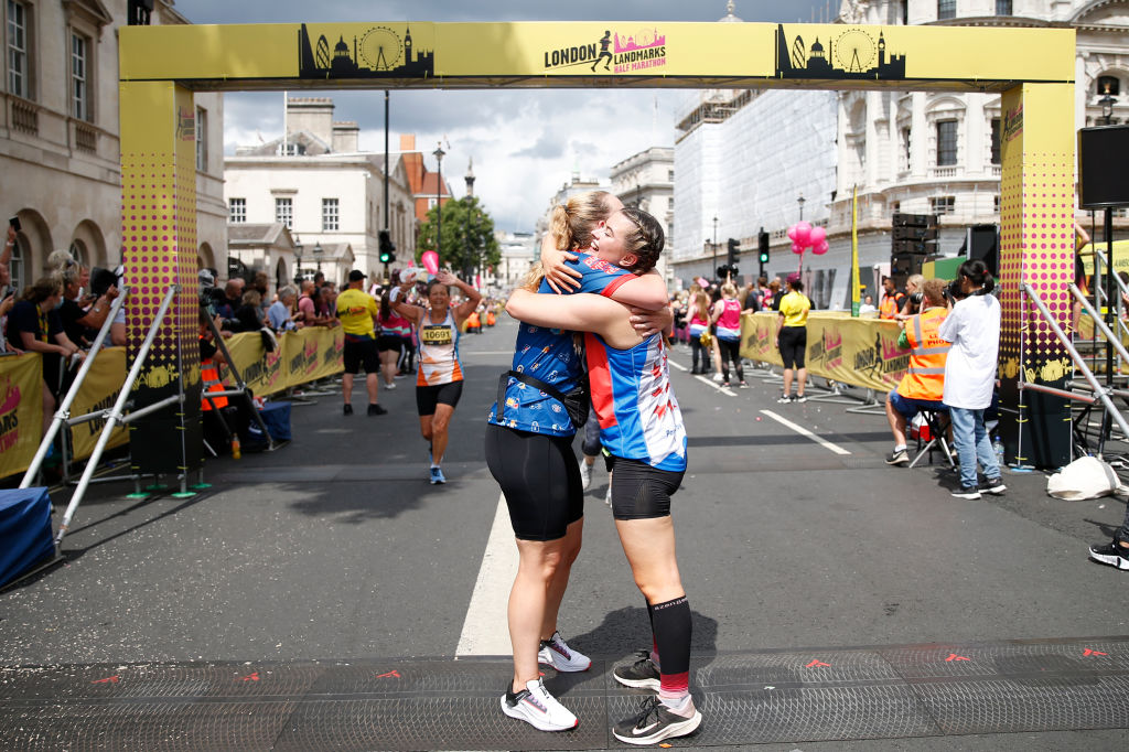 Two women hug after running the 2021 London Marathon