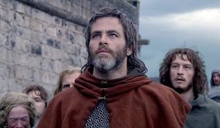 Outlaw King Chris Pine looks to the sky stoically, dressed in medieval garb