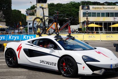 Picture shows a McLaren sports car carrying two Specialized McLaren Venge bikes