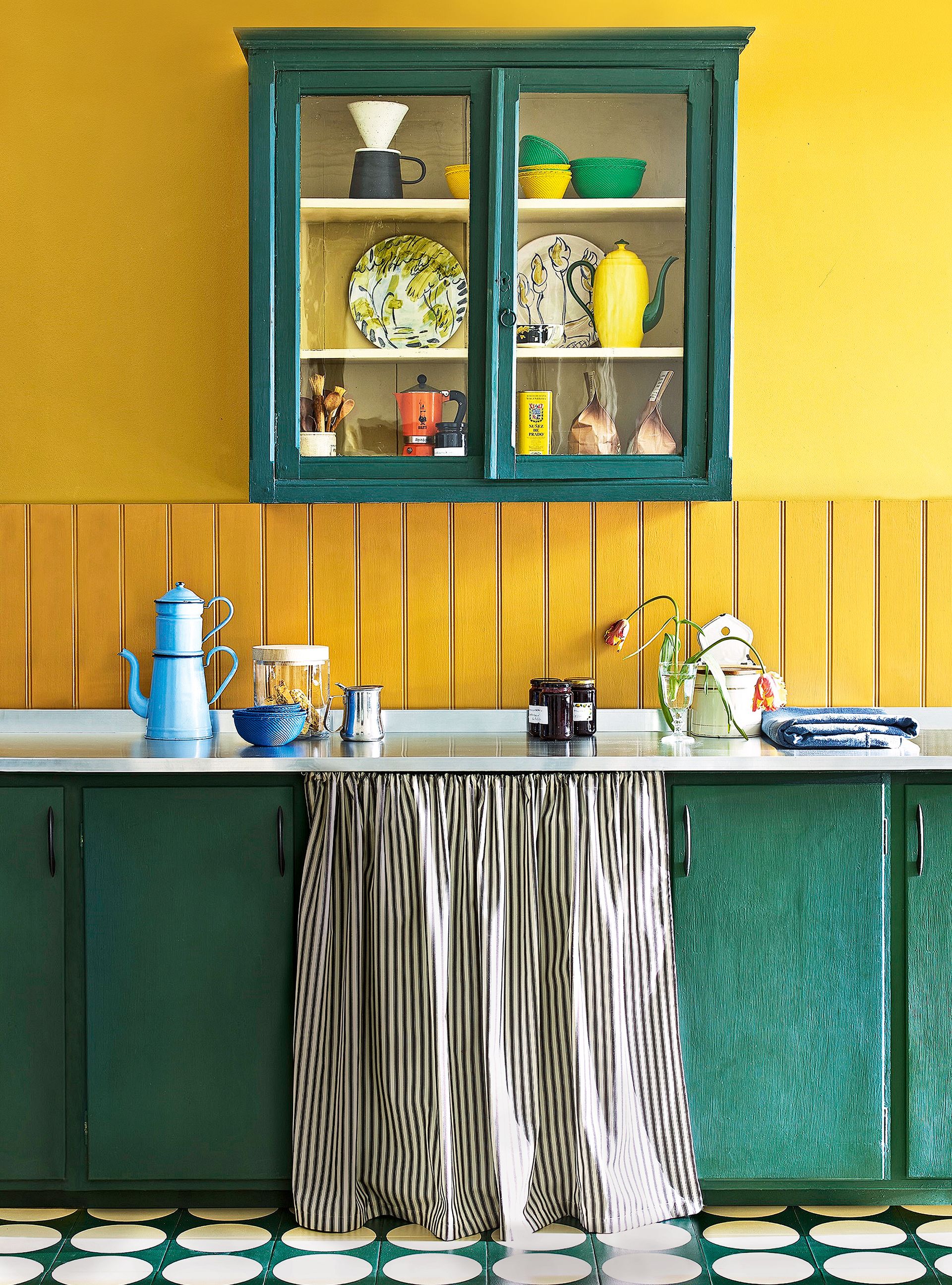 Yellow kitchen with green painted cabinet