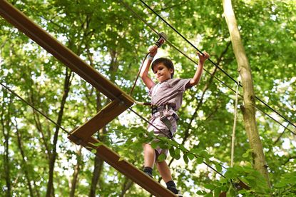 A child on a zip wire enjoy Go Ape - one of the family days out in the North East