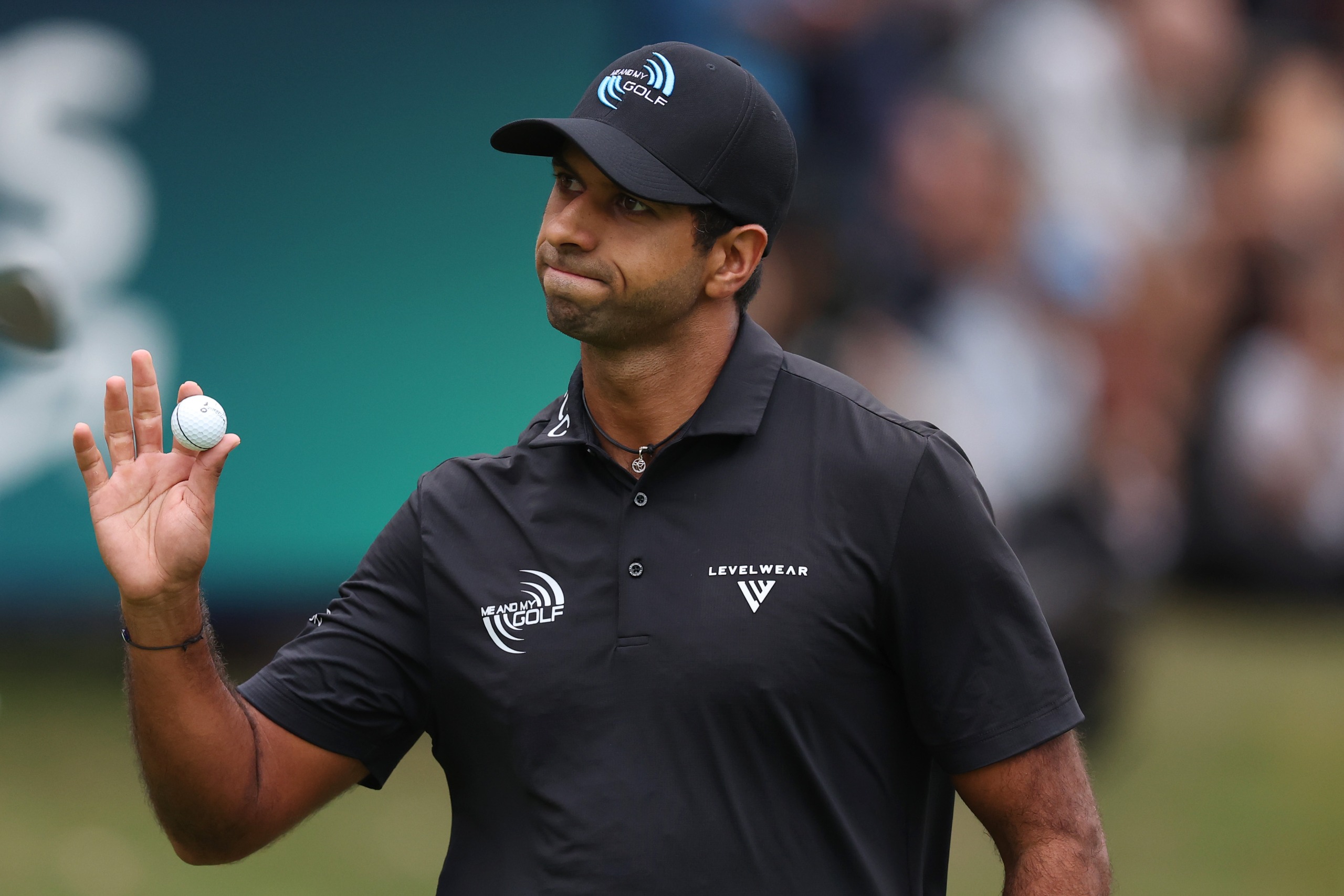 Aaron Rai holding up his golf ball in thanks to the crowd at the BMW PGA Championship 2026
