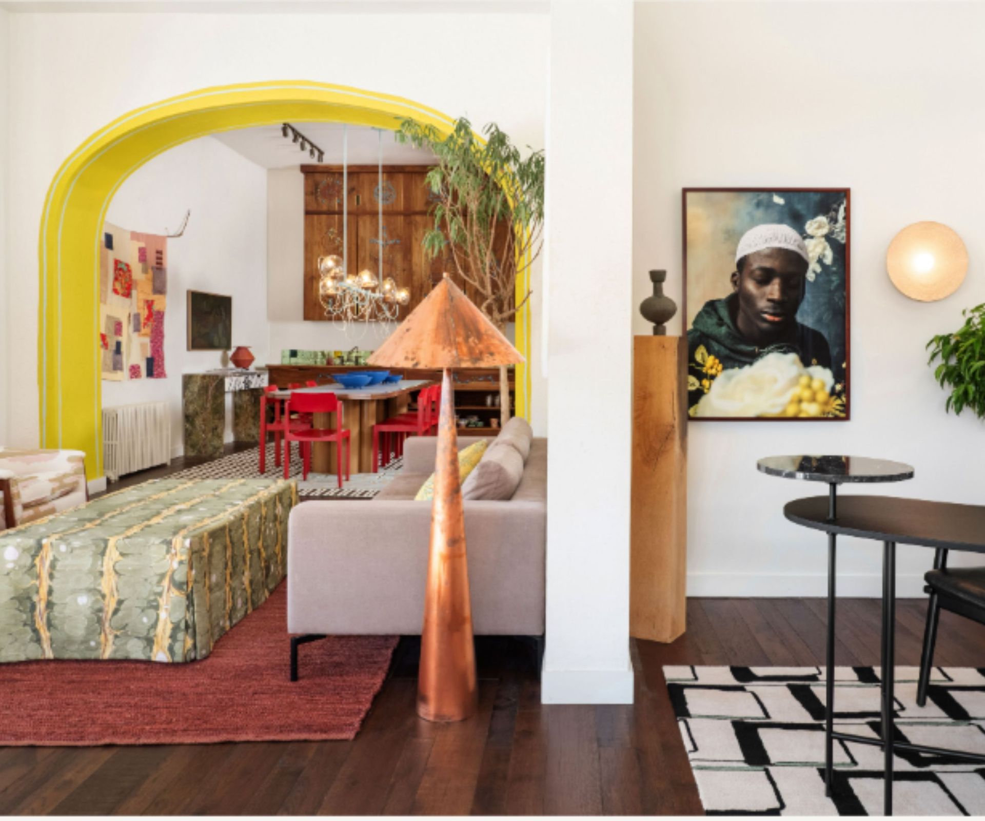 Colorful living room with yellow arch, geometric rug and upholstered furniture