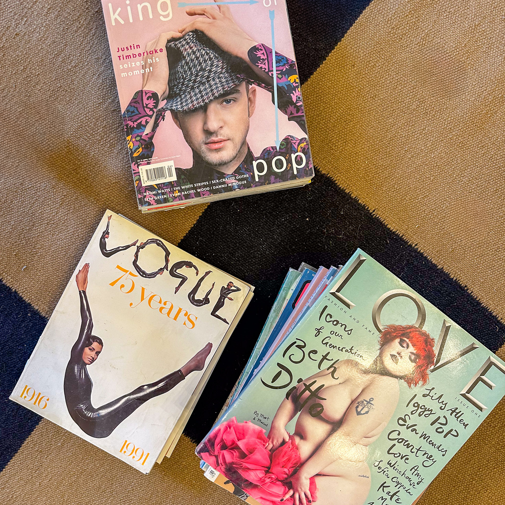 Three piles of vintage magazines, including Vogue and Love