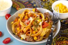 Plate of chicken bolognese with sweetcorn