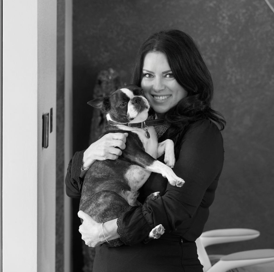 black and white image of woman holding a dog