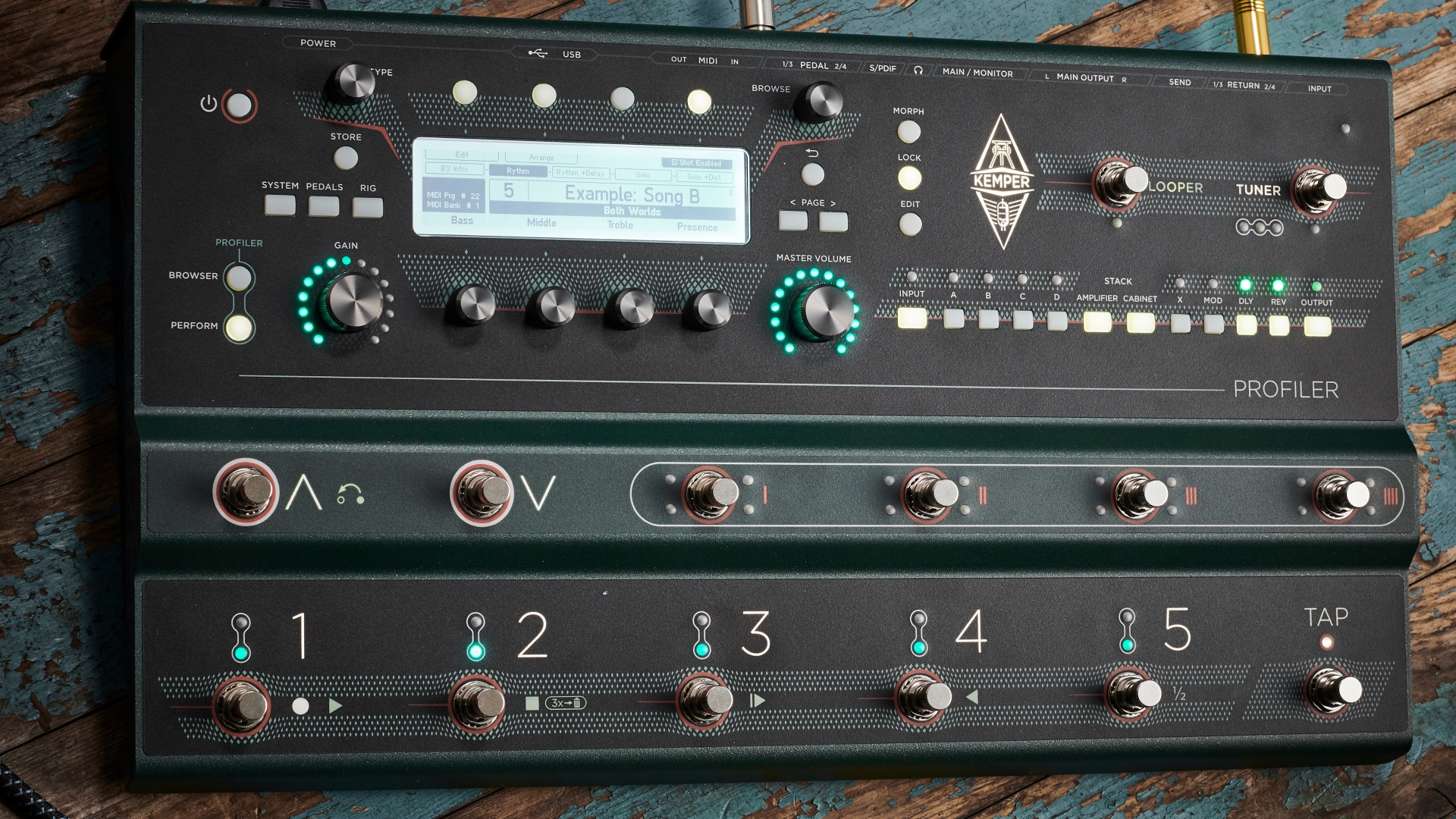 A Kemper Profiler Stage multi-effects pedal on a wooden floor
