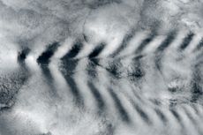 The tall peaks of Amsterdam Island interrupted air currents passing by and created cloud "waves."