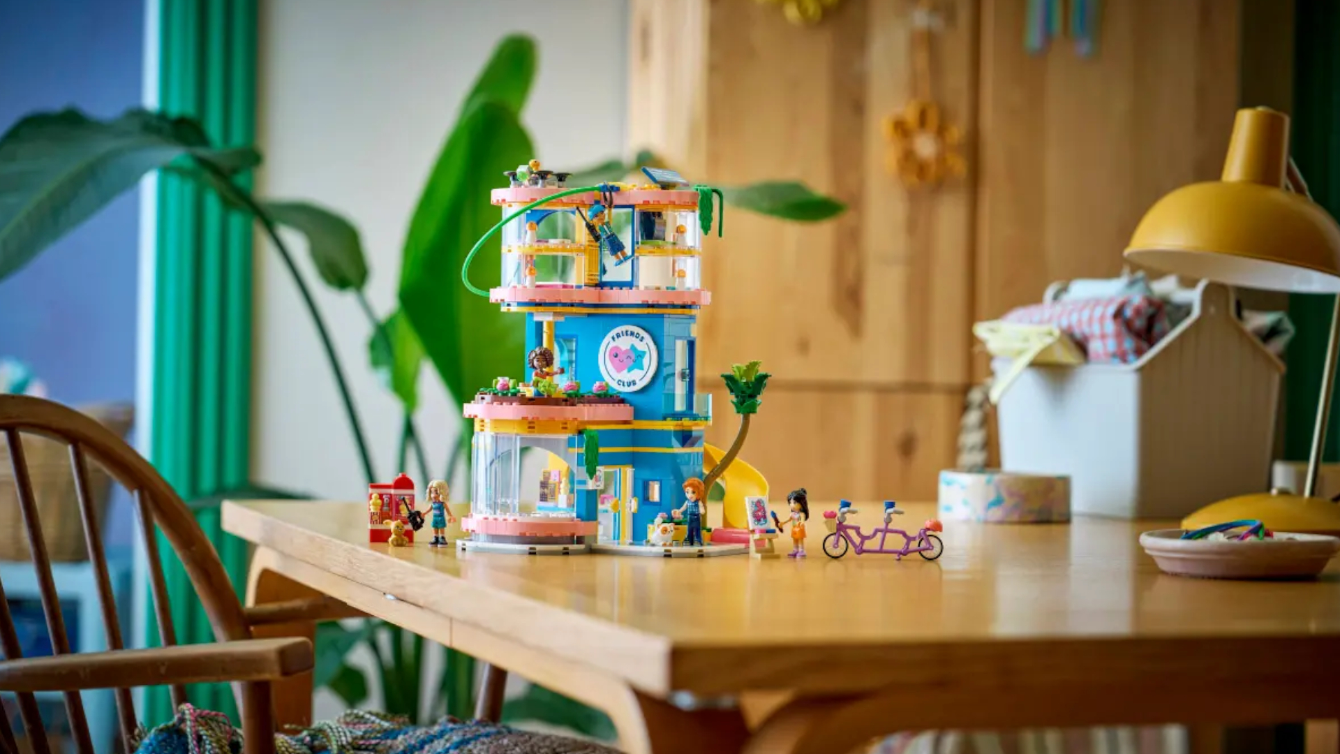A Lego playground house set on a wooden table