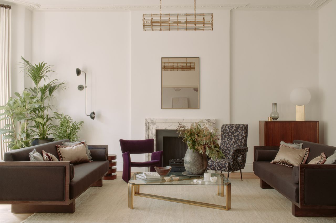 A living room with neutral decor and colorful seating