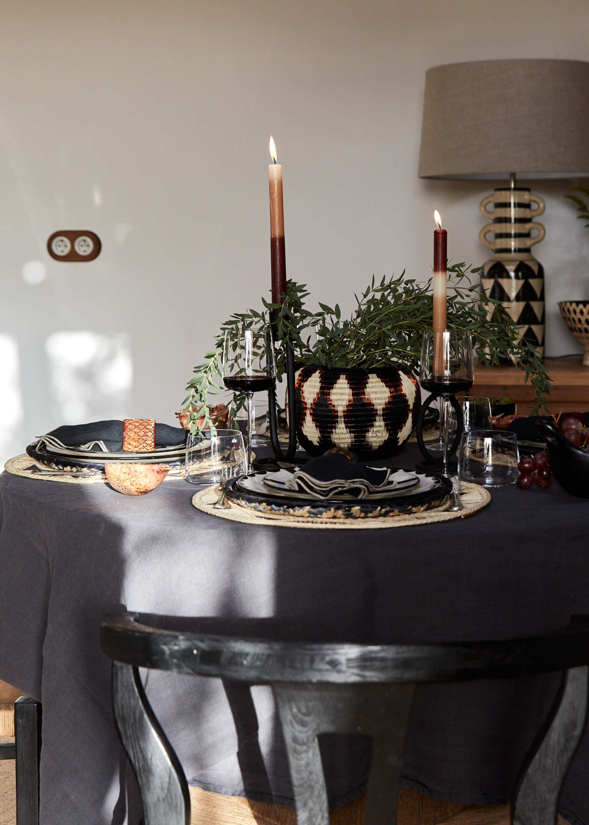 A moody dining room with cool-toned decor and tablescaping