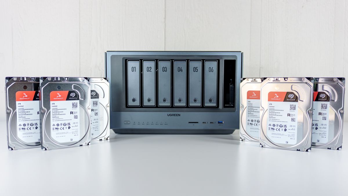 The Ugreen iDX6011 Pro NAS on a table with six hard drives