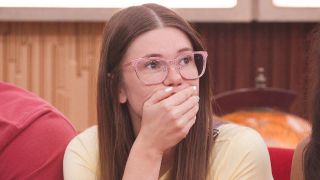 Kelley Jorgensen with her hand over her mouth.