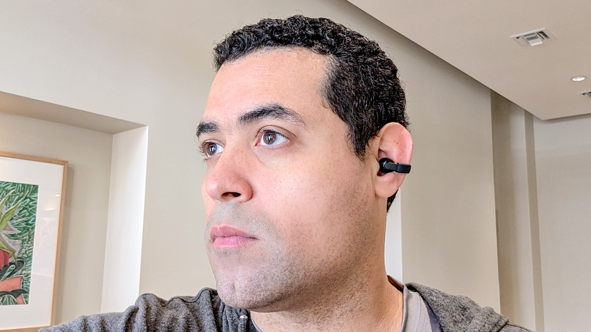 The Sony LinkBuds Clip in a Tom's Guide reviewer's hands and ears.