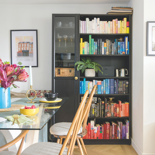 bookshelf with books organised by colour