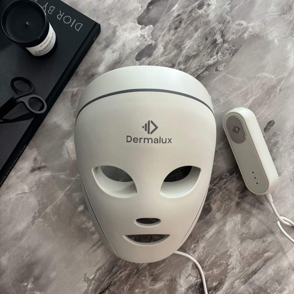 The Dermalux LED Face Mask on a marble table