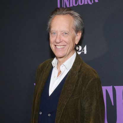 A portrait of actor Richard E. Grant at a movie premiere