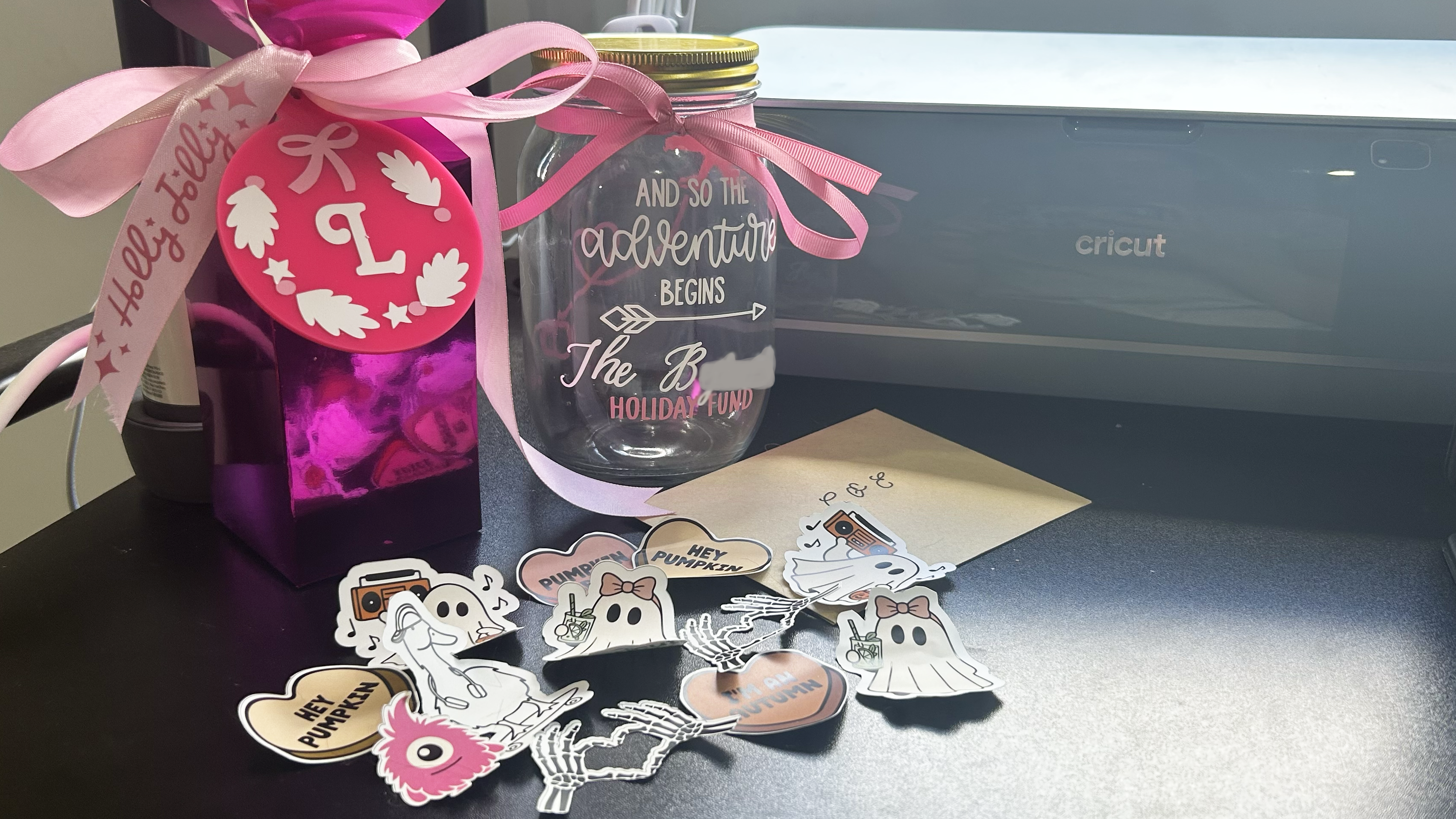 Various projects made by Lucy Scotting with the Cricut Maker 4, including Stickers, box, ornament and card envelope