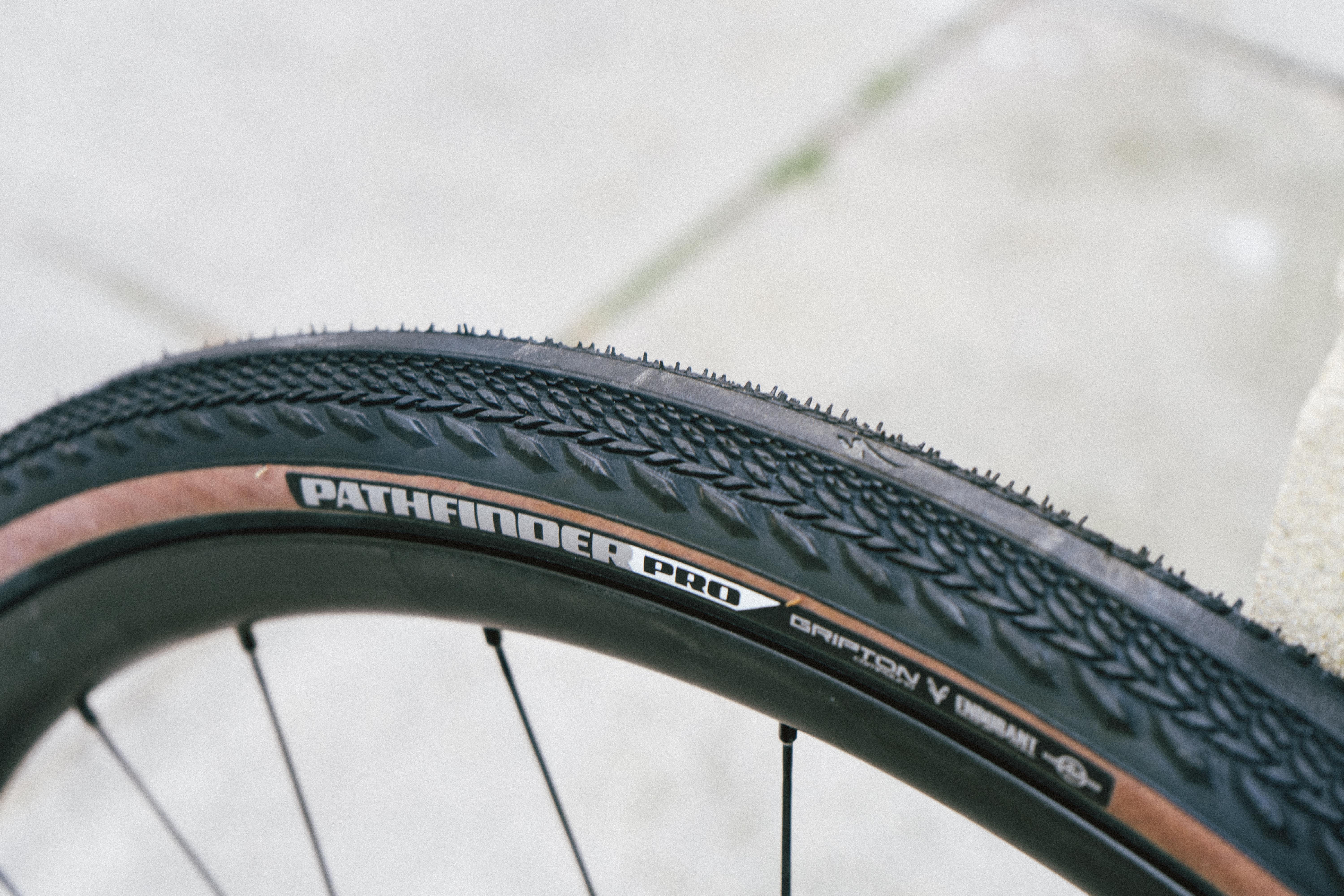 A tan gravel tyre against a stone wall