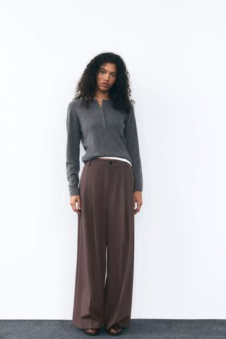 model wearing zara brown pleated trousers