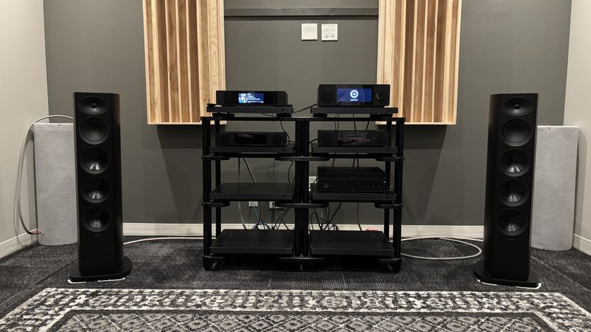 Arcam Radia R45 speakers in a listening room either side of a hi-fi rack with Arcam electronics