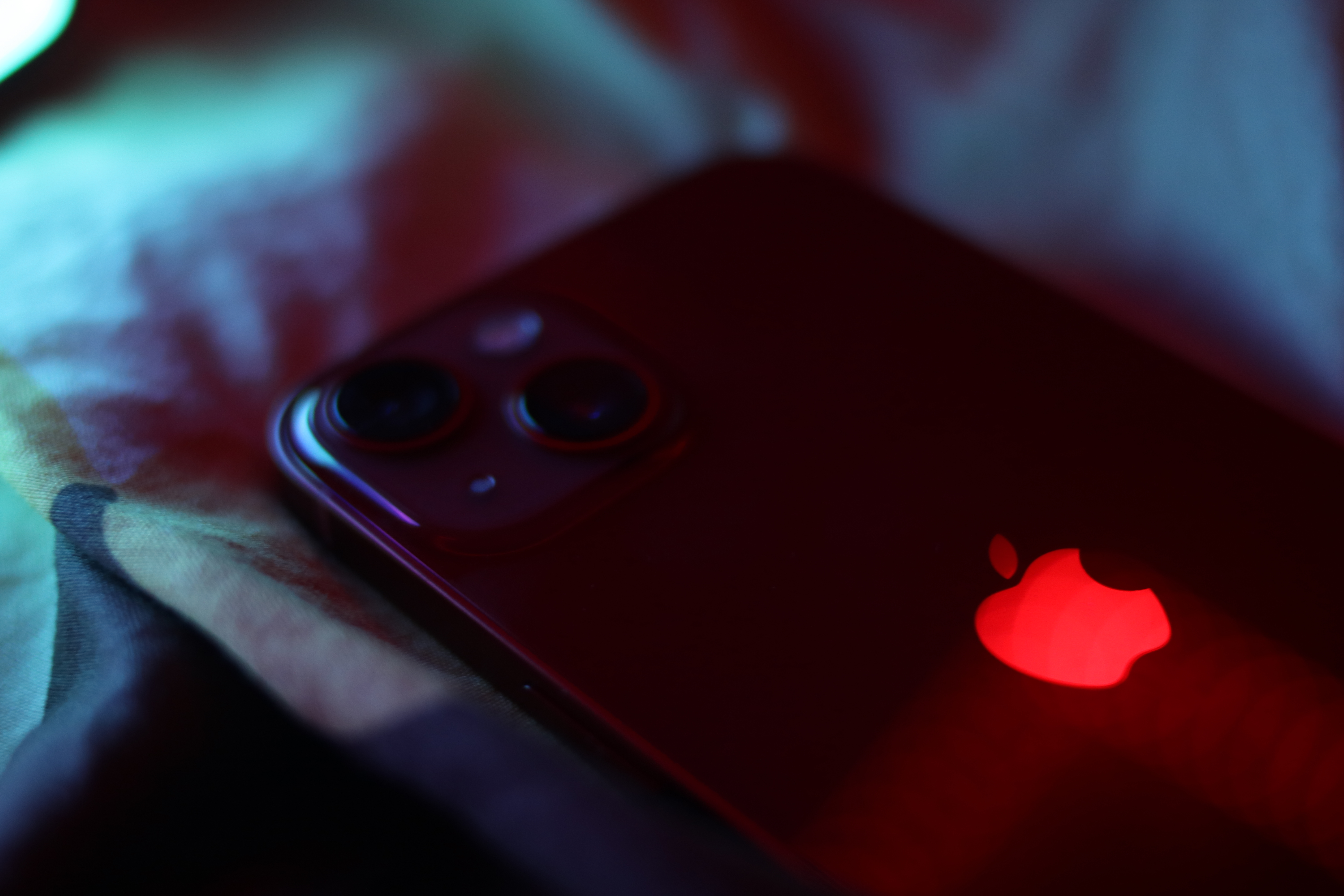 iPhone13 handset with glowing Apple logo