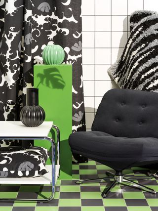 A black retro swivel chair in a bright patterned room
