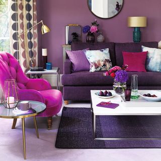 living room with purple sofa and lamp