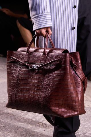 model carrying red bag on bottega veneta spring 2025 runway