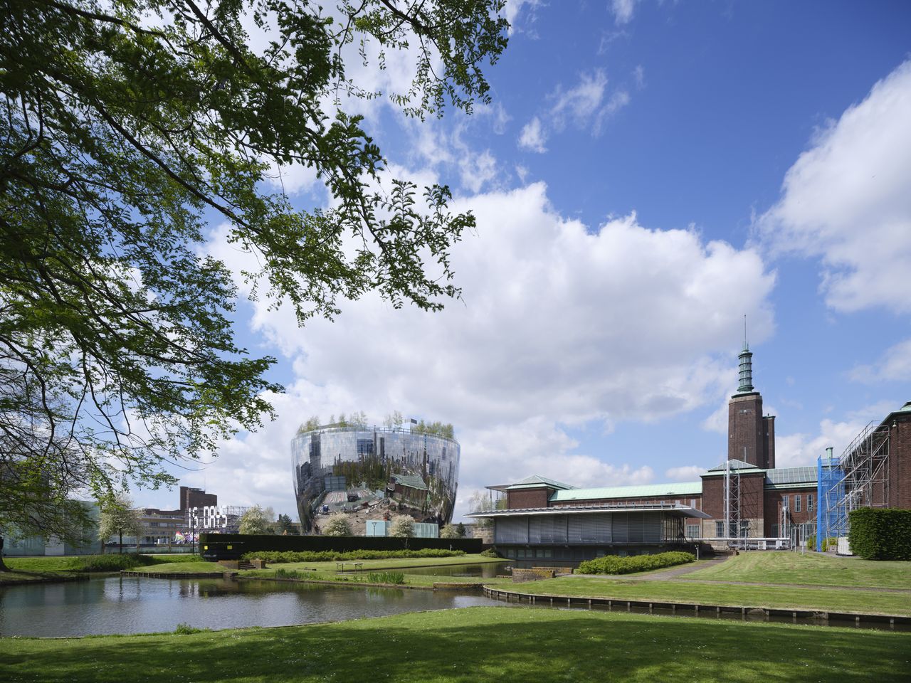 Greenery with a large mirror building in the distance