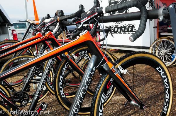 A stable of Kona carbon bikes await their riders.
