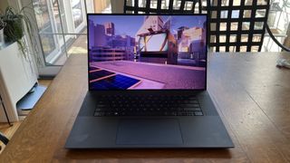 Dell XPS 17 laptop in use on a wooden desk