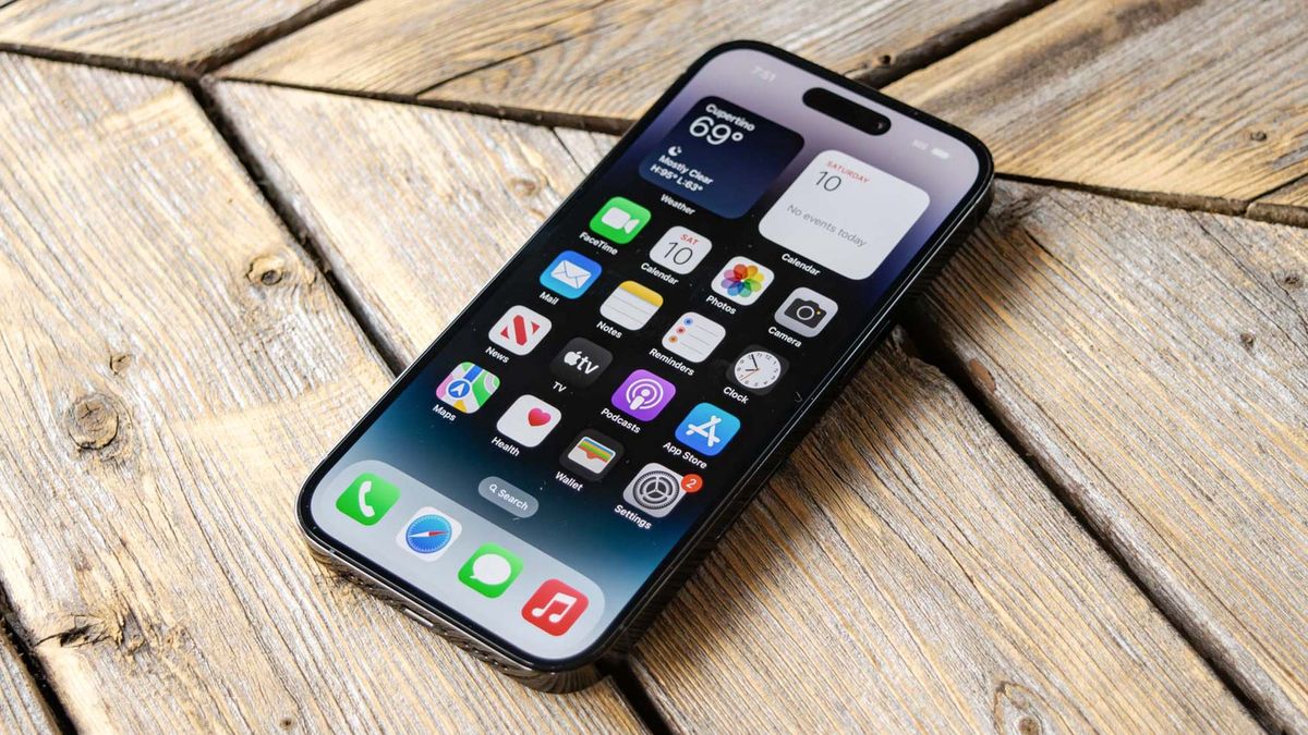 iPhone 14 Pro shown from front displaying iOS16 home screen