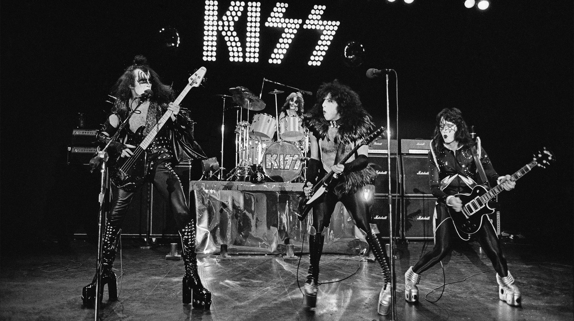 DETROIT, USA - 16th MAY: American rock group Kiss perform live on stage at Cobo Hall in Detroit during the concert recording of Alive! on 16th May 1975. Left to right: Gene Simmons, Peter Criss, Paul Stanley and Ace Frehley.