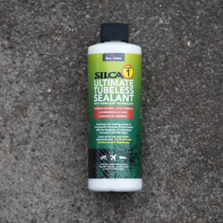 A bottle of Silca Ultimate Tubeless Sealant on a concrete background
