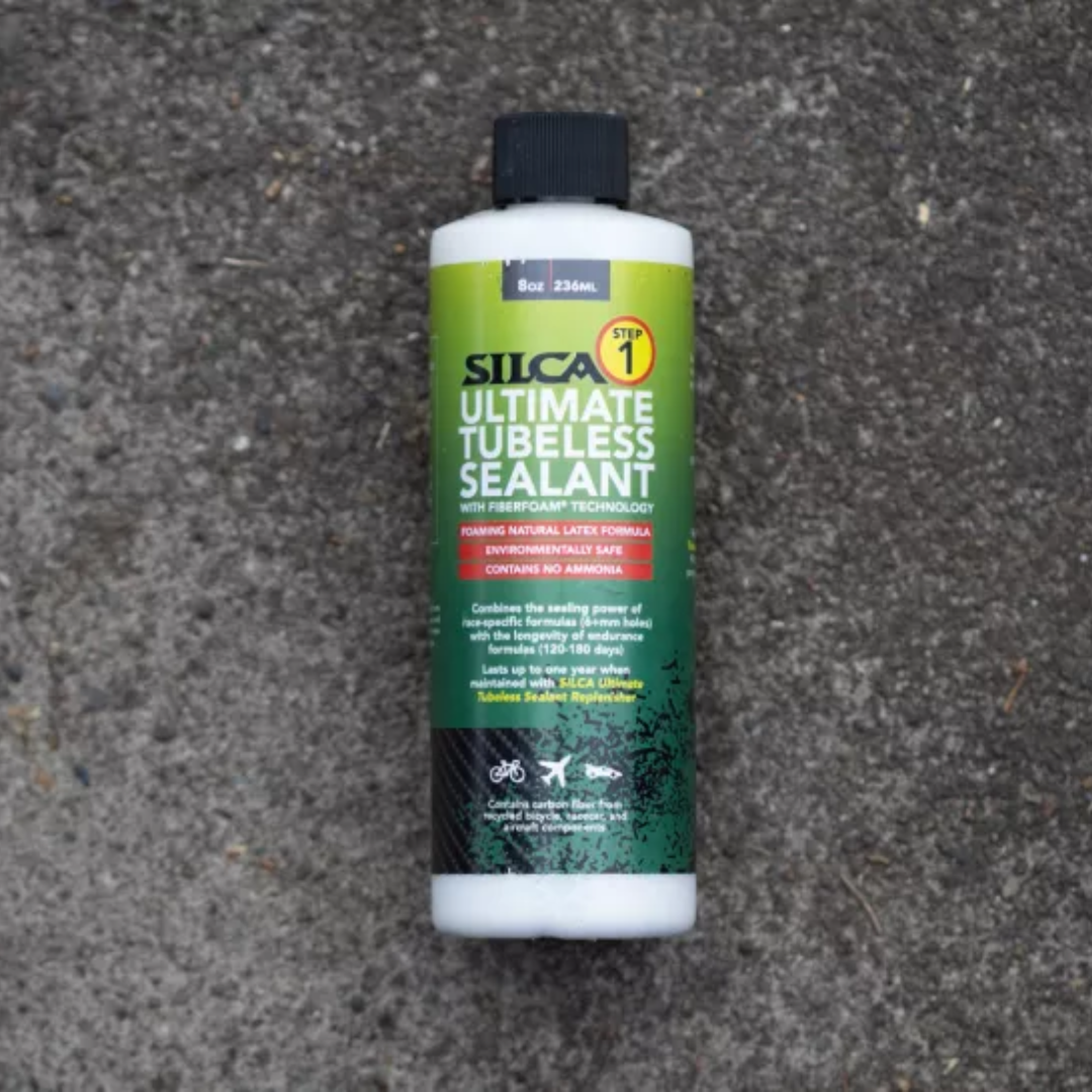 A bottle of Silca Ultimate Tubeless Sealant on a concrete background