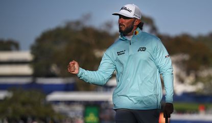 Homa fist pumps on the 18th green after his victory