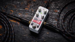 Electro-Harmonix Pico Swello: the compact mini-pedal is finished in white and has black and white text, four knobs, and is photographed against a distressed wood floor.