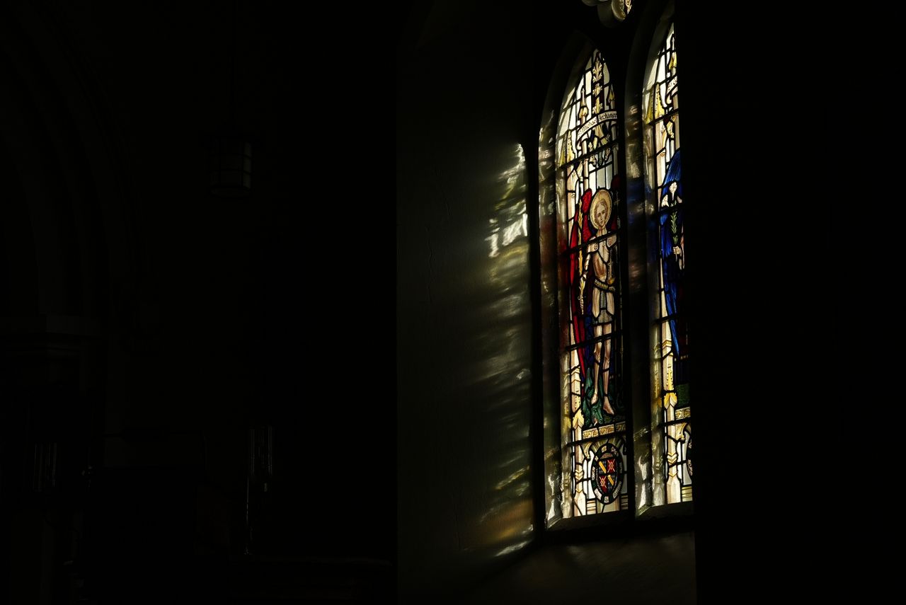 A stained glass window with light coming through it