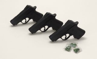 Three hand0guns and three packets containing small bullets.