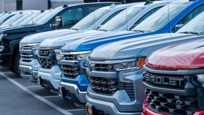 A line of cars at the dealership.