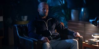 Jason Statham sits in a chair in Wrath of Man