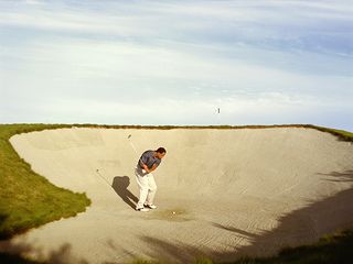 Man playing a bunker shot